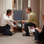 Technician discussing heater fix with family