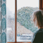 Person looking out a wintery window