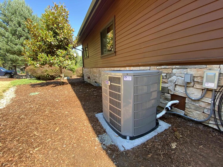 air conditioner outside brown house