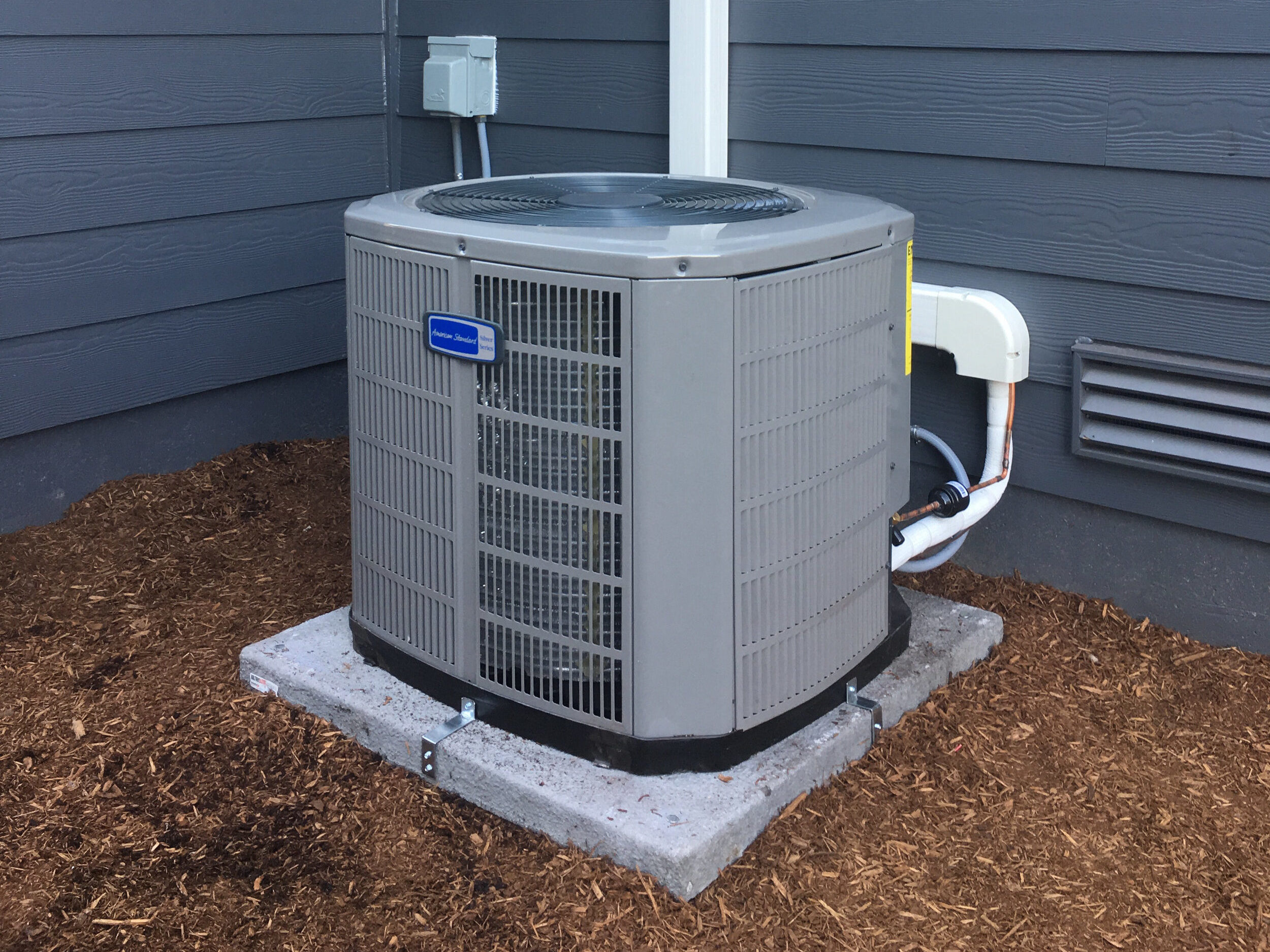 air conditioner outside gray house