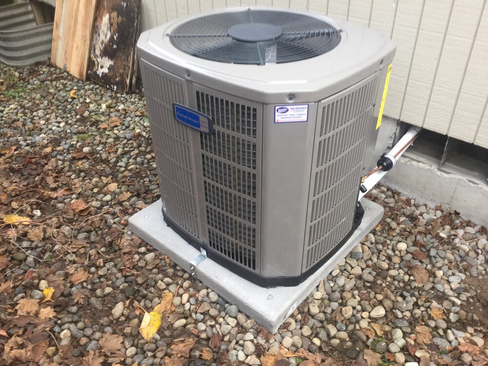 air conditioner sitting on rocks