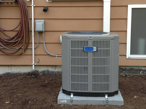 air conditioner outside brown house