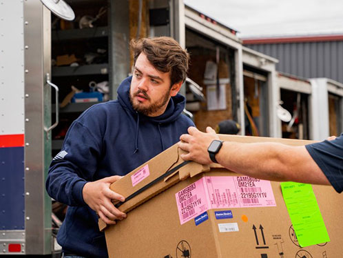 Technicians moving a box